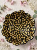 Top view of the black and gold flower-shaped decorative bowl with hand-painted gold dots on spiral coils